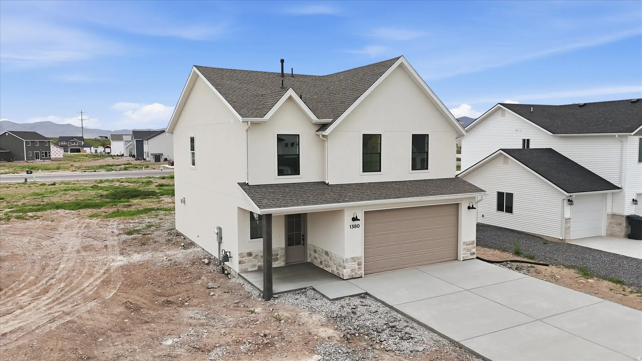 Contemporary two-story residence with white siding and a dark shingle roof