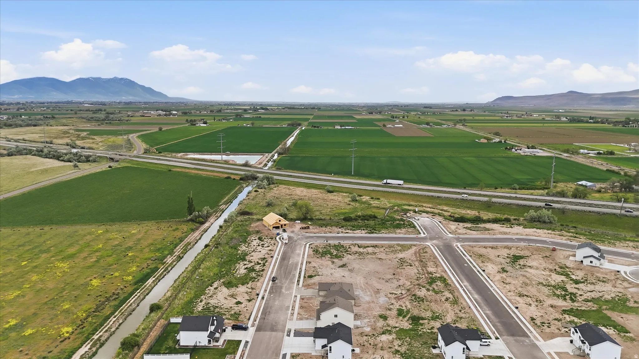 Developing residential area featuring newly paved streets and a partially constructed home