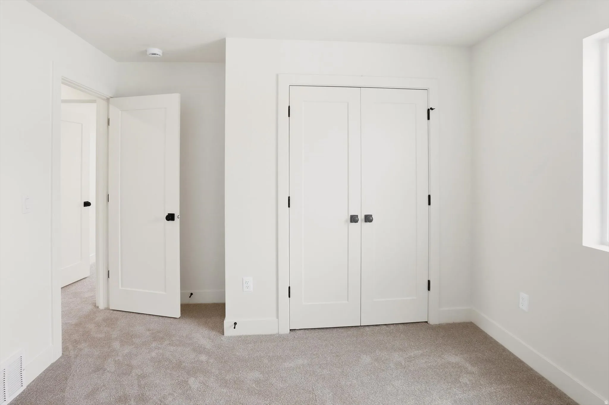 Neutral-toned carpet flooring complementing white walls and trim