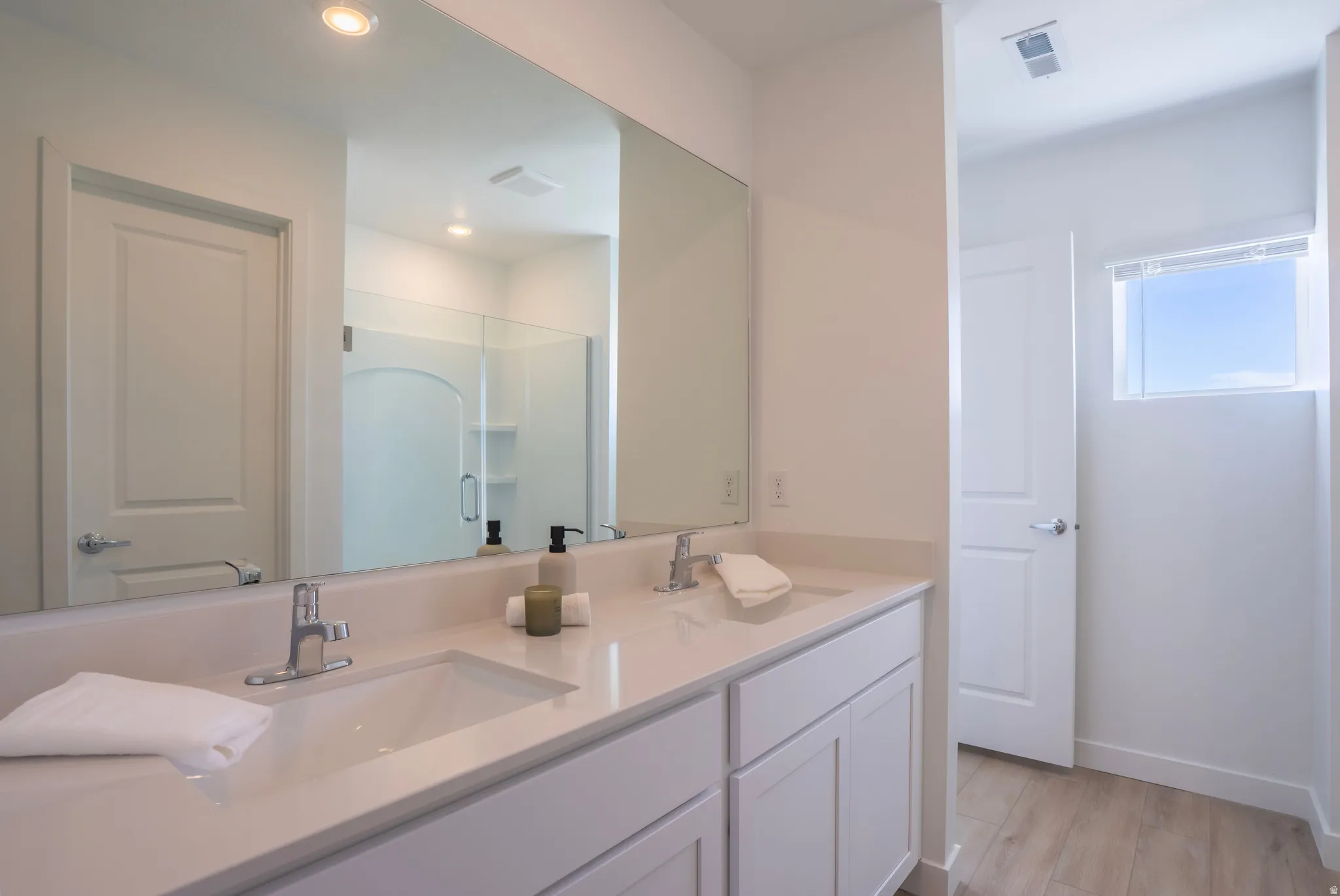 Dual vanity with undermount sinks, chrome fixtures, and a spacious countertop