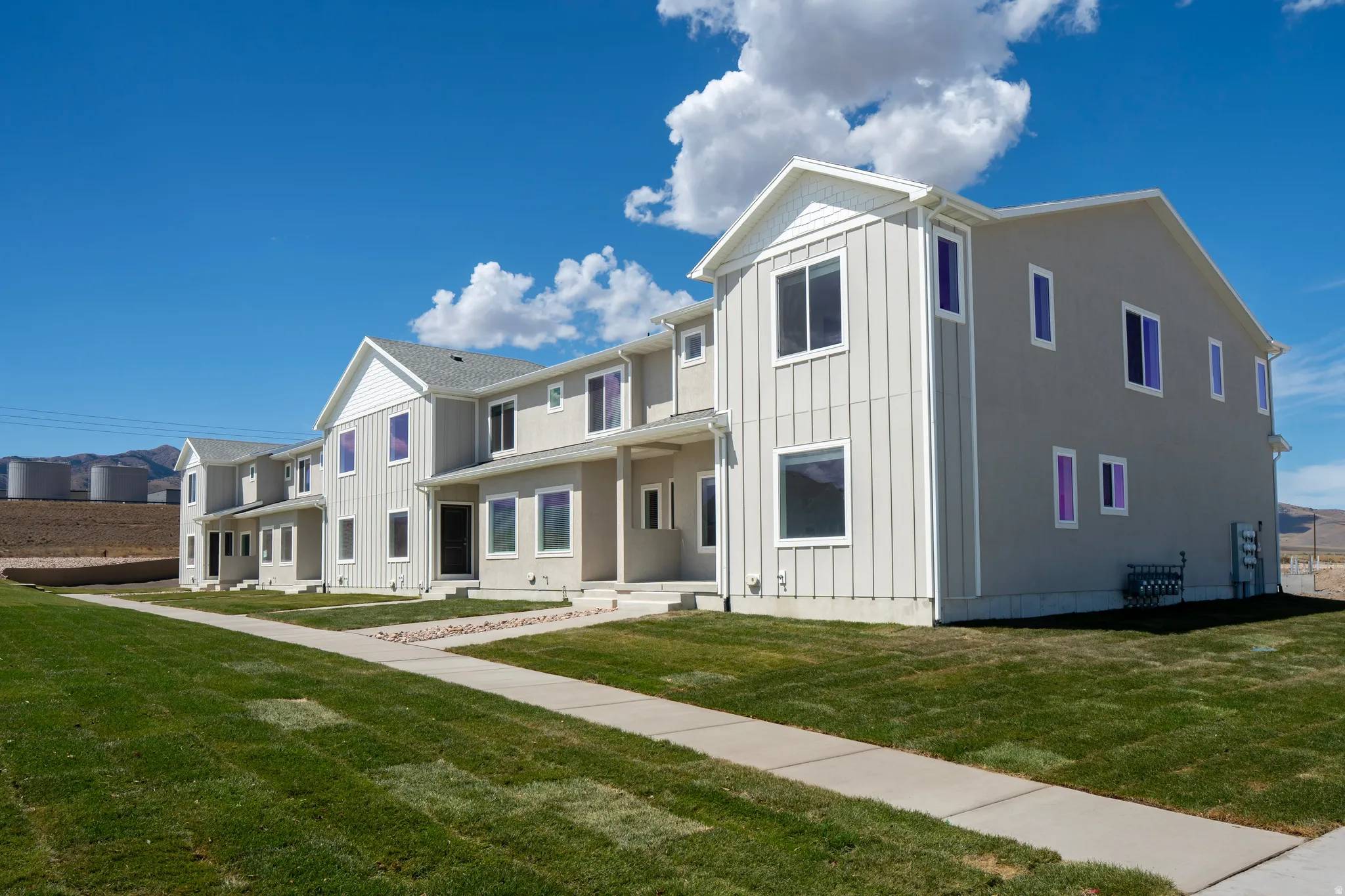 Contemporary multi-story exterior with vertical siding accents and stucco finishes