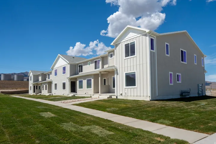 Contemporary multi-story exterior with vertical siding accents and stucco finishes