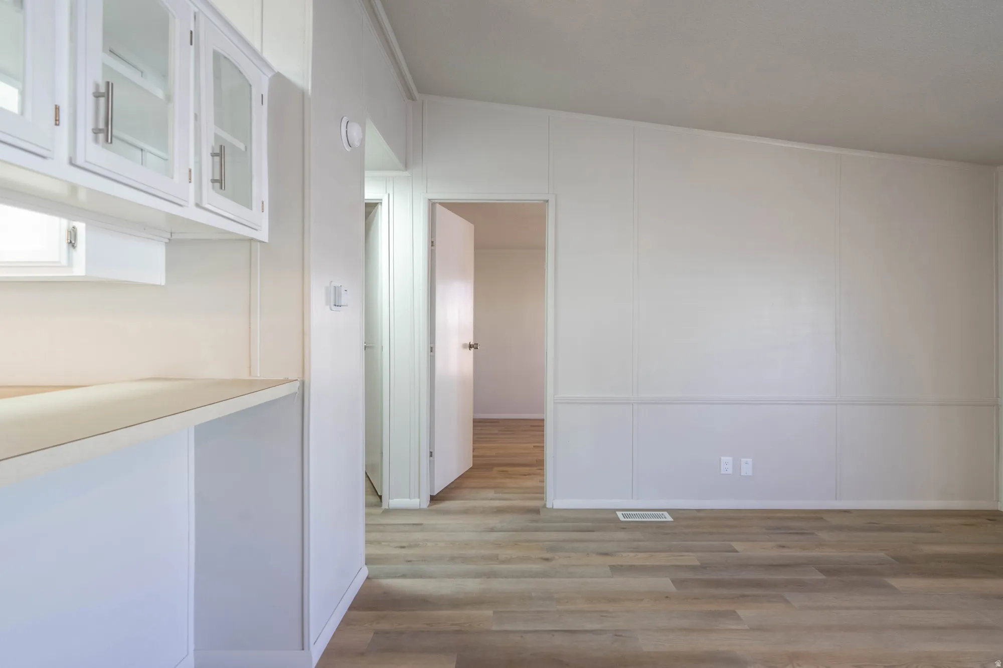 Open concept space featuring light wood-finish flooring