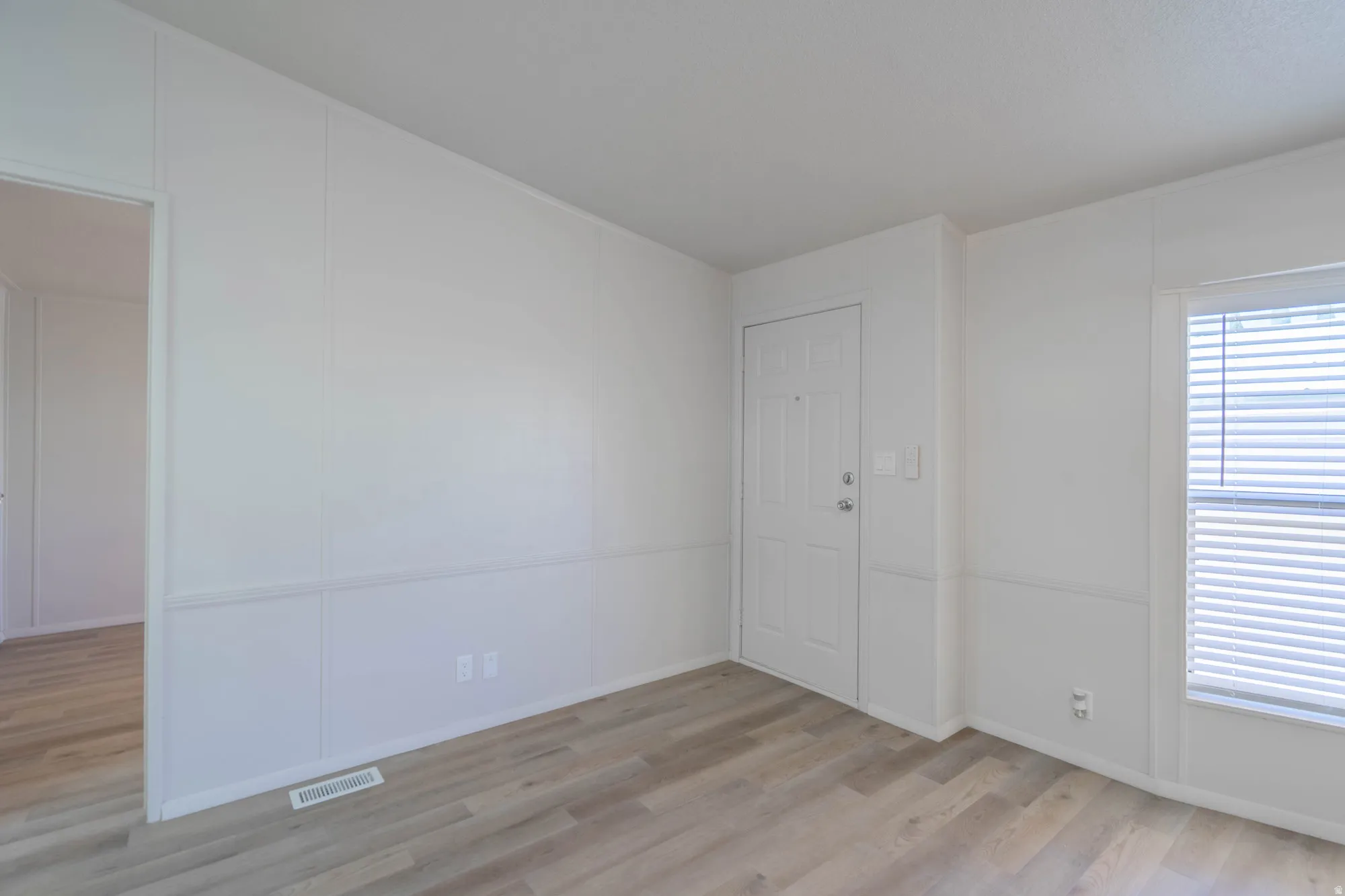 Spacious room with light wood-finish flooring