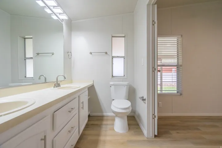 Bathroom with a double vanity featuring integrated sinks and brushed nickel fixtures