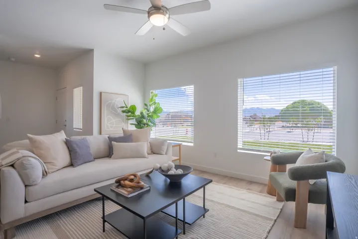 Recessed lighting, wood-finish flooring, and a ceiling fan with integrated lighting