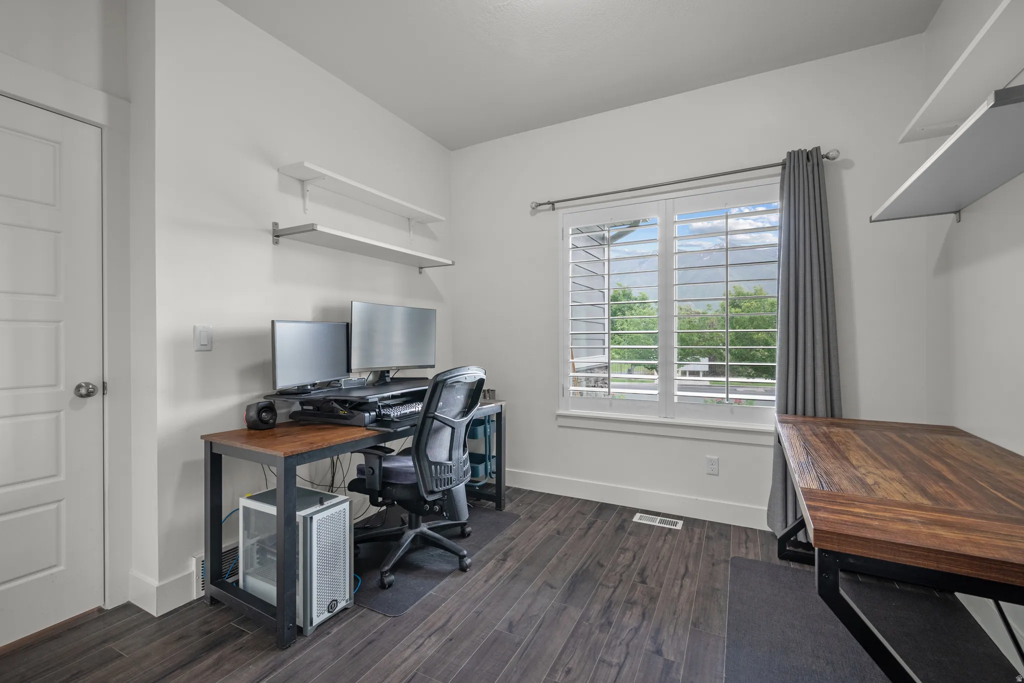 Third bedroom currently being used as an office . Includes breathtaking views of the mountain, the shelving and the closet is located on opposite side of the window.