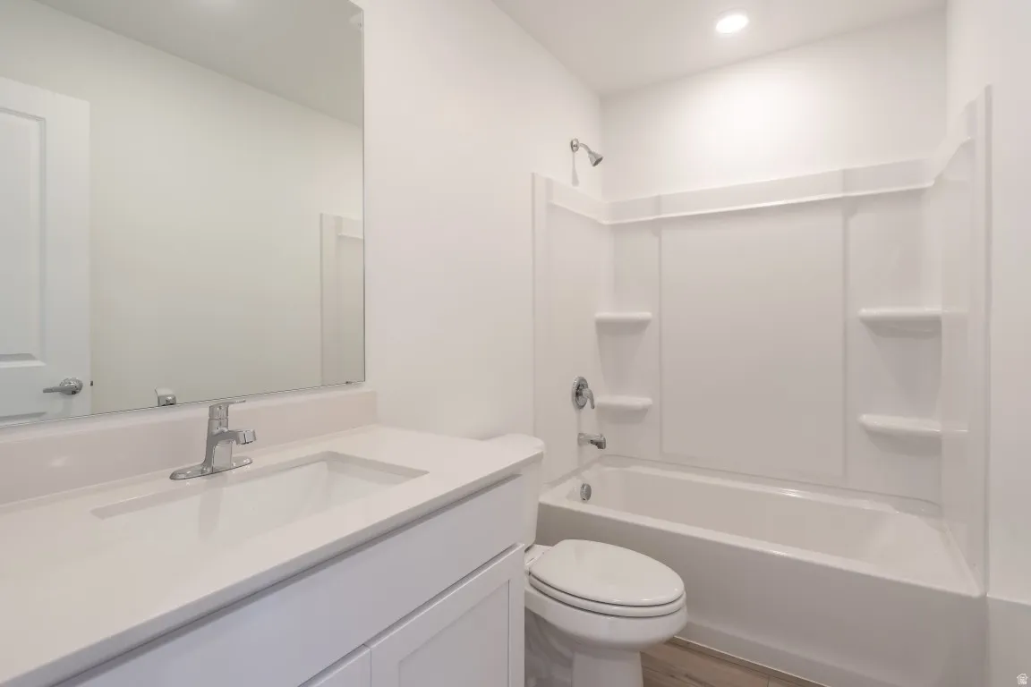 Vanity with a single basin sink, chrome faucet, and integrated countertop