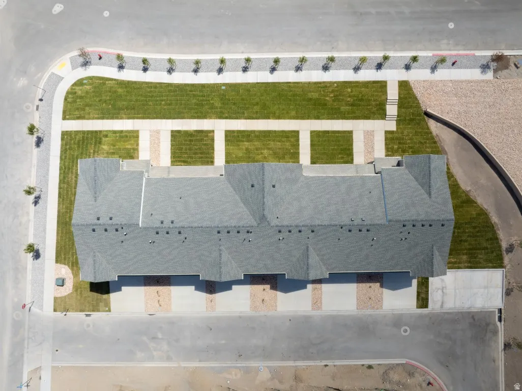 Townhome structure with a gray shingle roof and multiple dormers