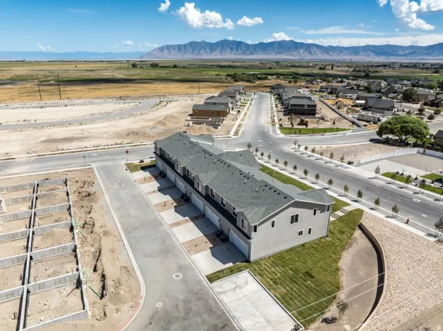 Townhome community with mountain scenery, paved roads, and developing infrastructure