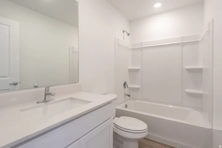 Vanity with a single basin sink, chrome faucet, and integrated countertop