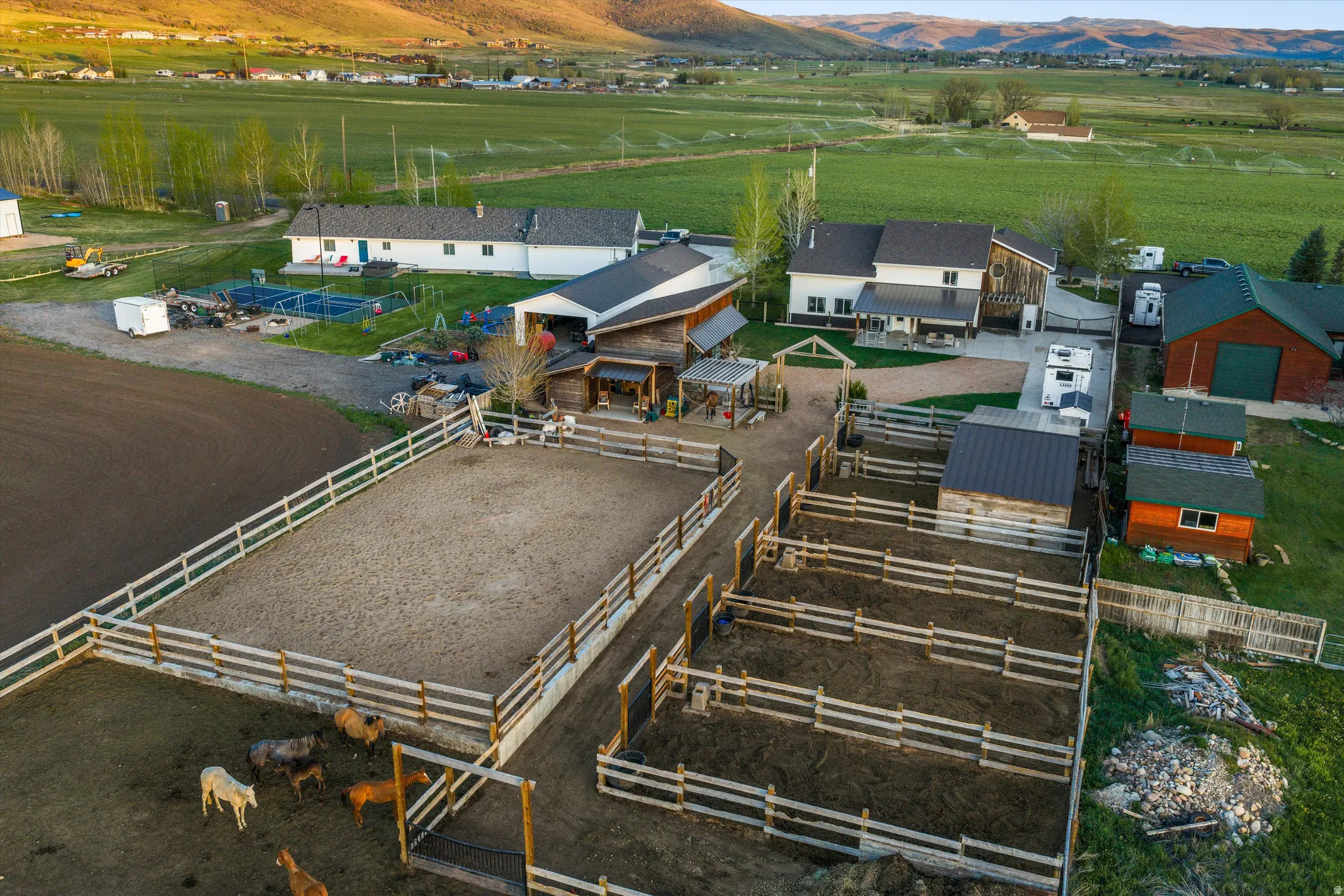 Expansive property featuring a riding arena, multiple corrals, and various outbuildings