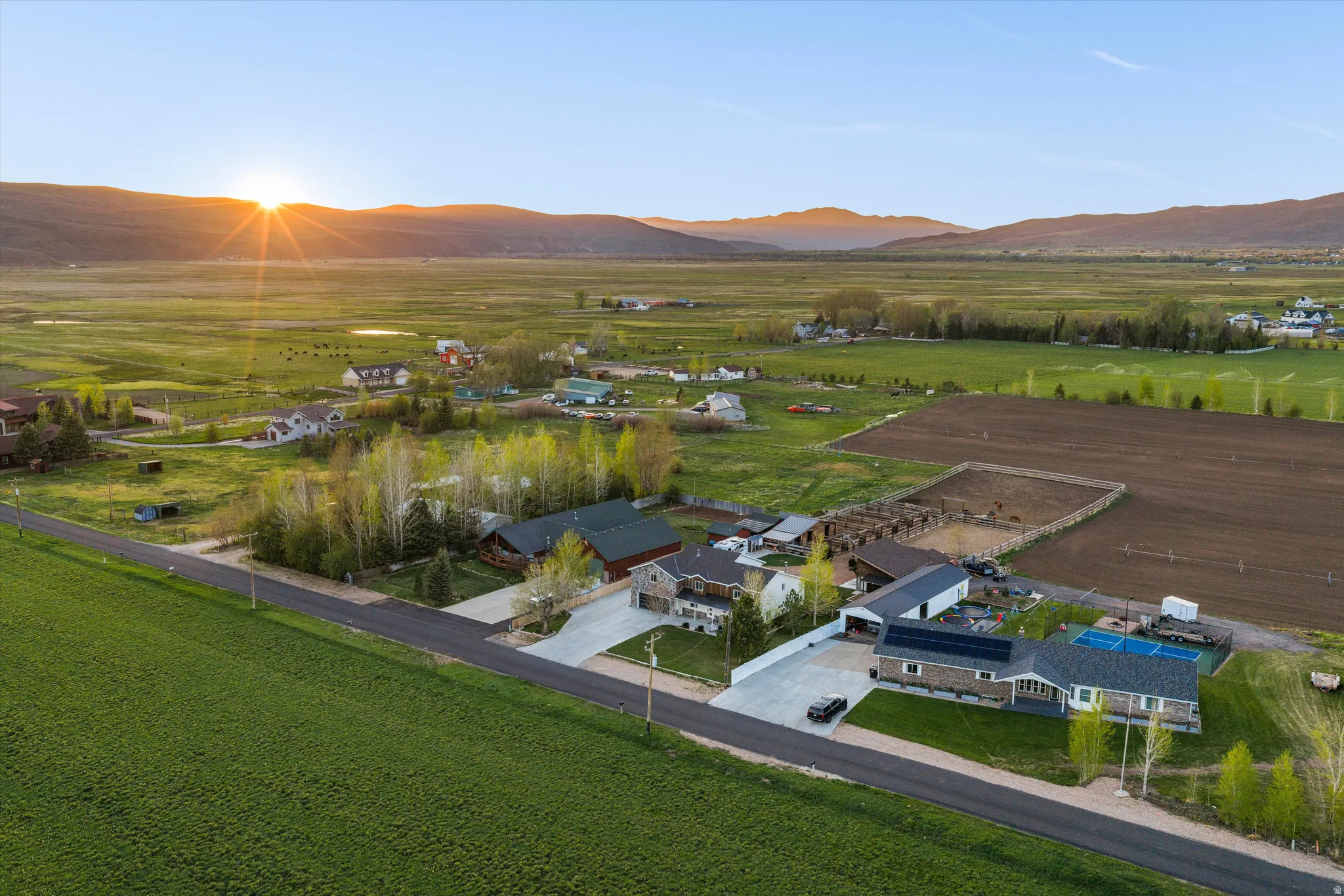 Aerial perspective featuring multiple residential structures and agricultural land