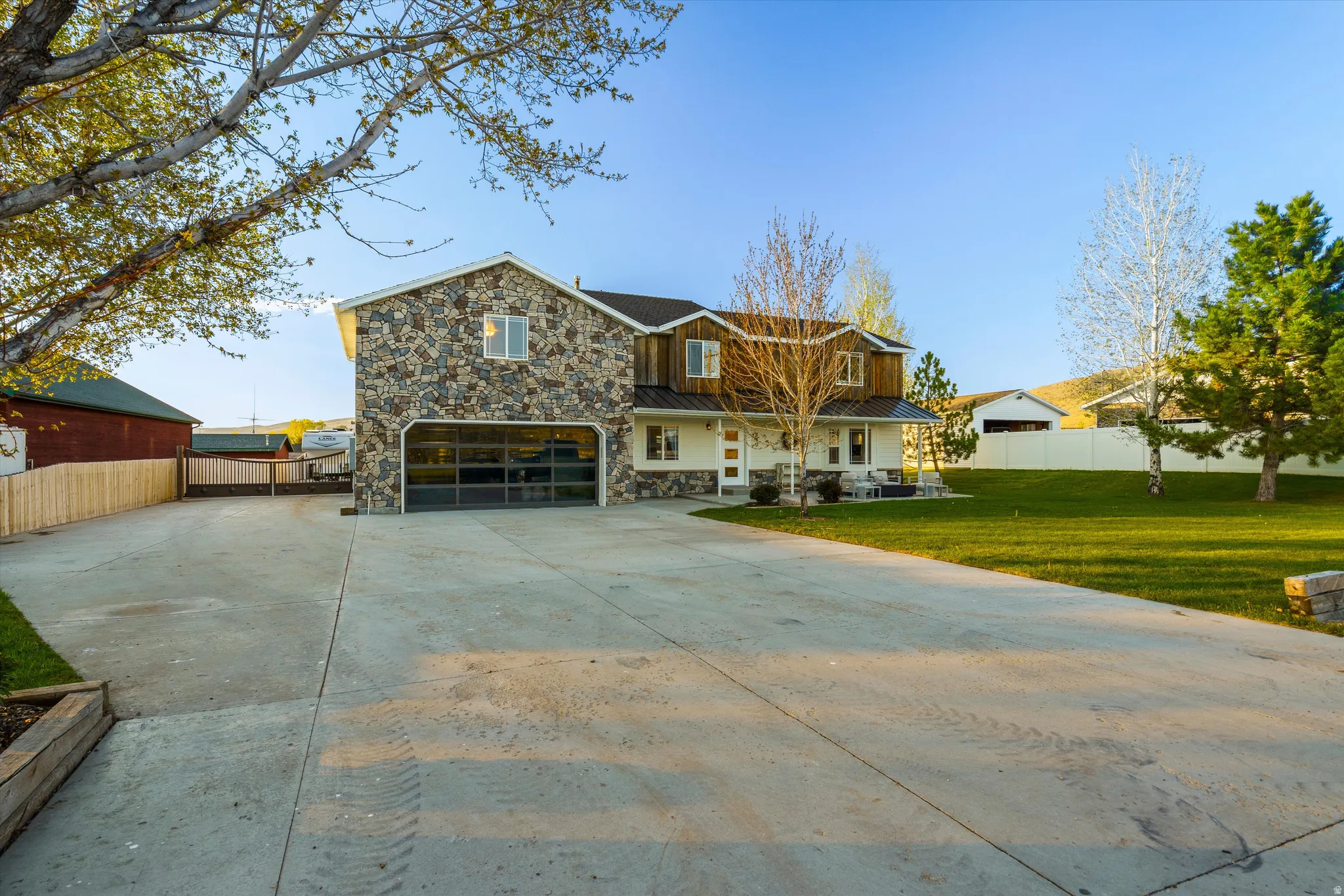Stone and siding exterior with a clear panel garage door