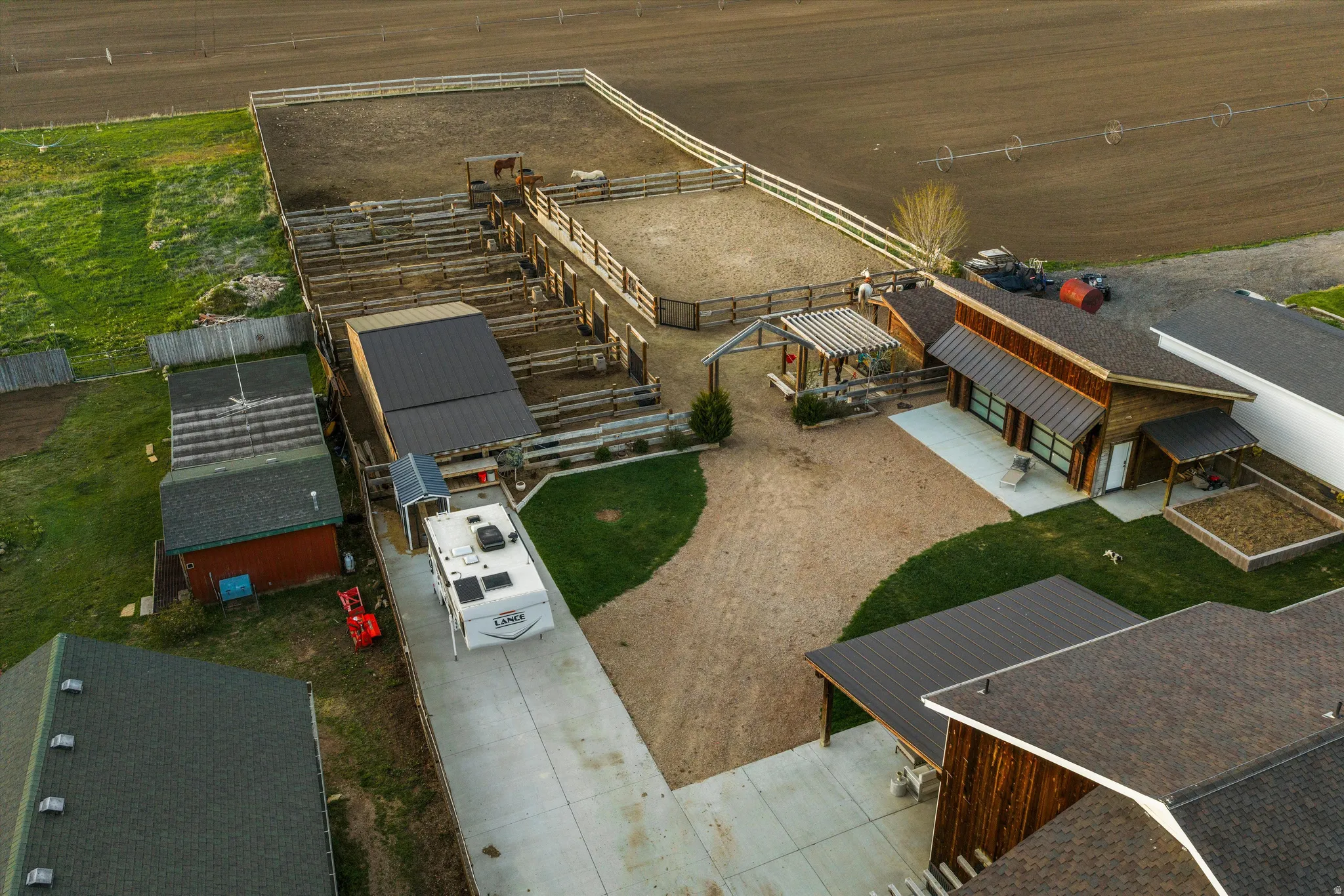 Expansive equestrian facilities featuring a large arena and multiple pens