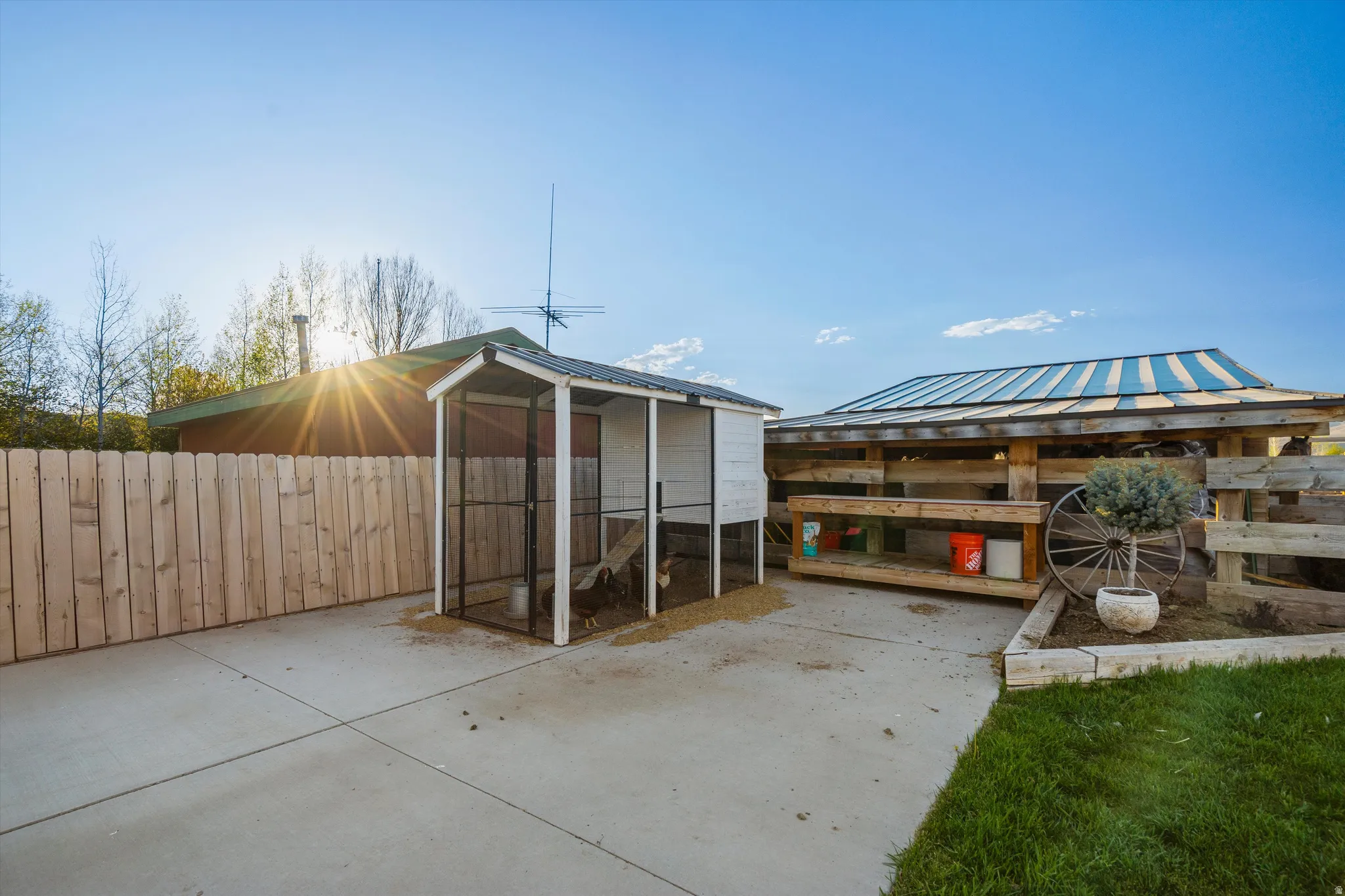 Outdoor concrete patio area featuring a wooden privacy fence