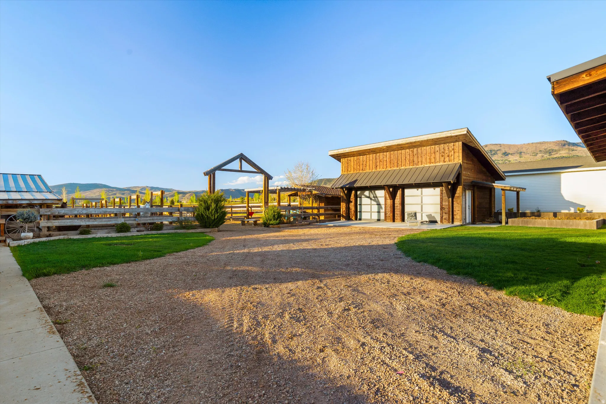 Wood-sided outbuilding featuring two full-view garage doors and a metal roof