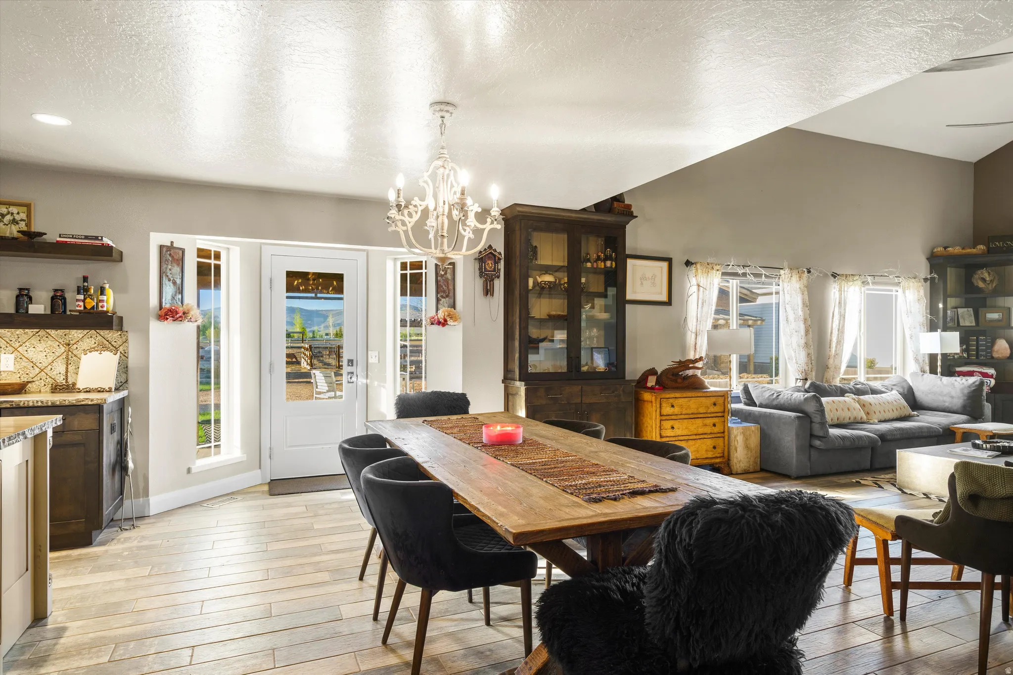 Spacious dining area featuring wood-finish flooring and a decorative chandelier