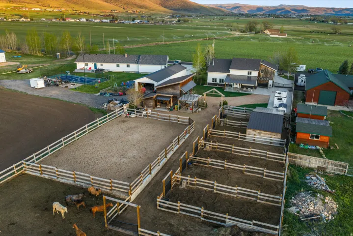 Expansive property featuring a riding arena, multiple corrals, and various outbuildings