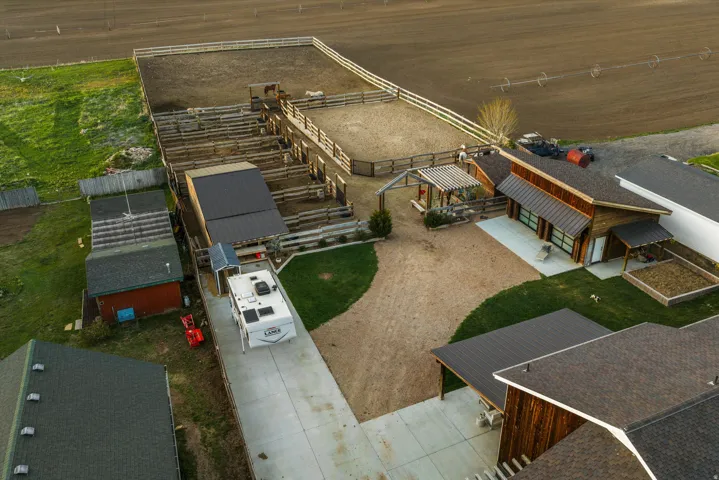 Expansive equestrian facilities featuring a large arena and multiple pens