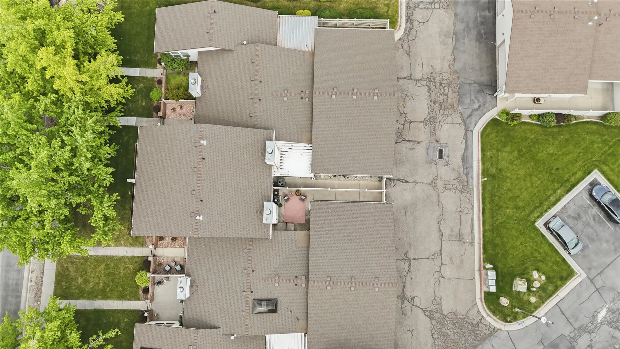 Brown shingle roofing with visible air conditioning units and skylights