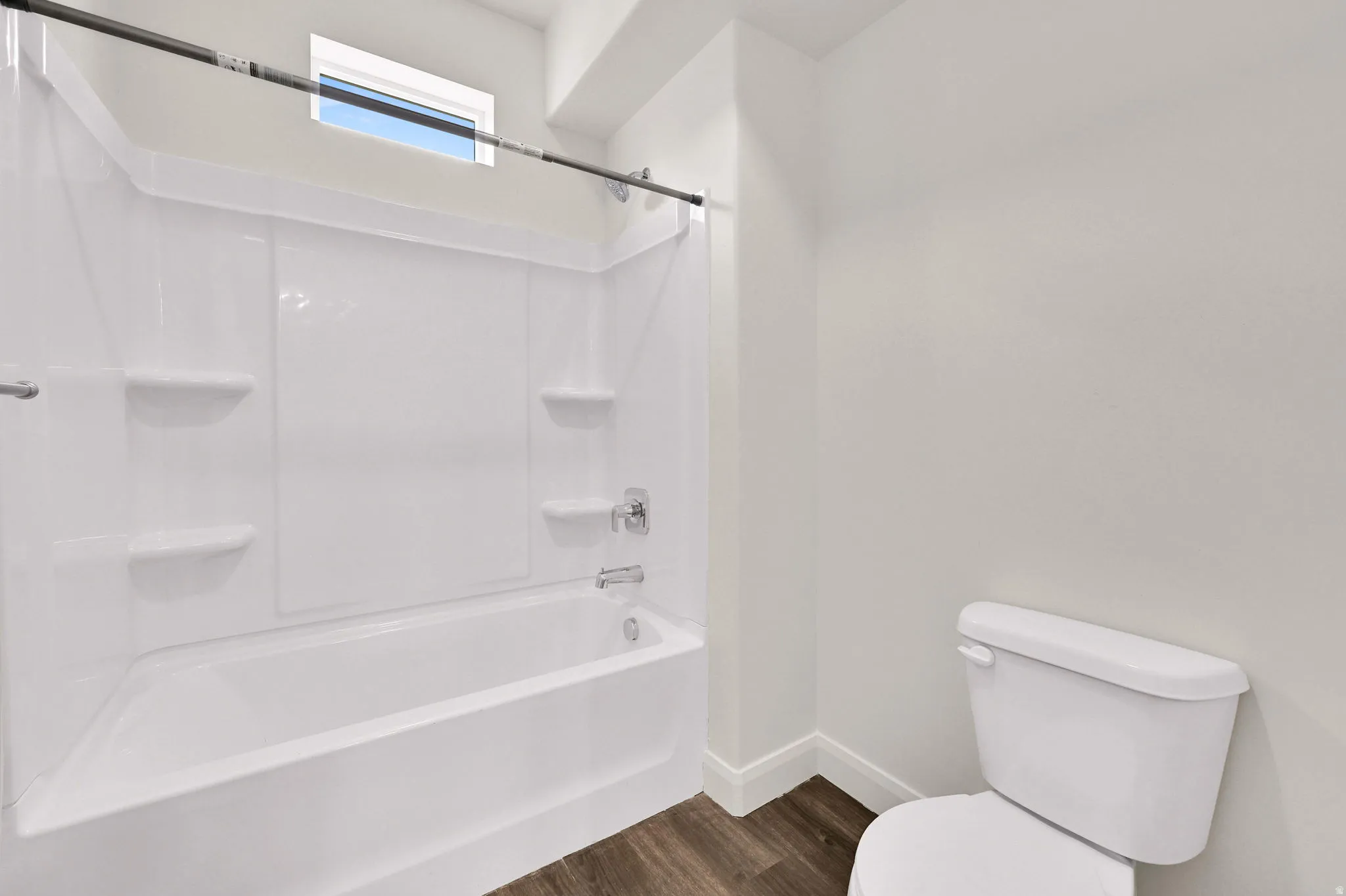 Bathroom featuring a white tub with integrated shelving, chrome fixtures, and a shower curtain rod
