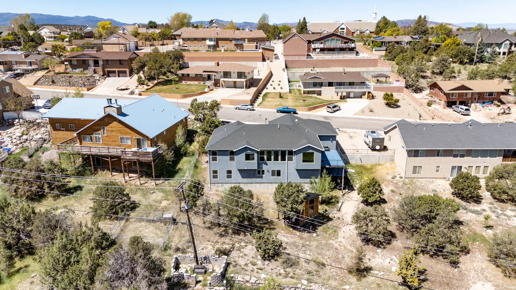 Gray-sided residence with dark shingle roofing