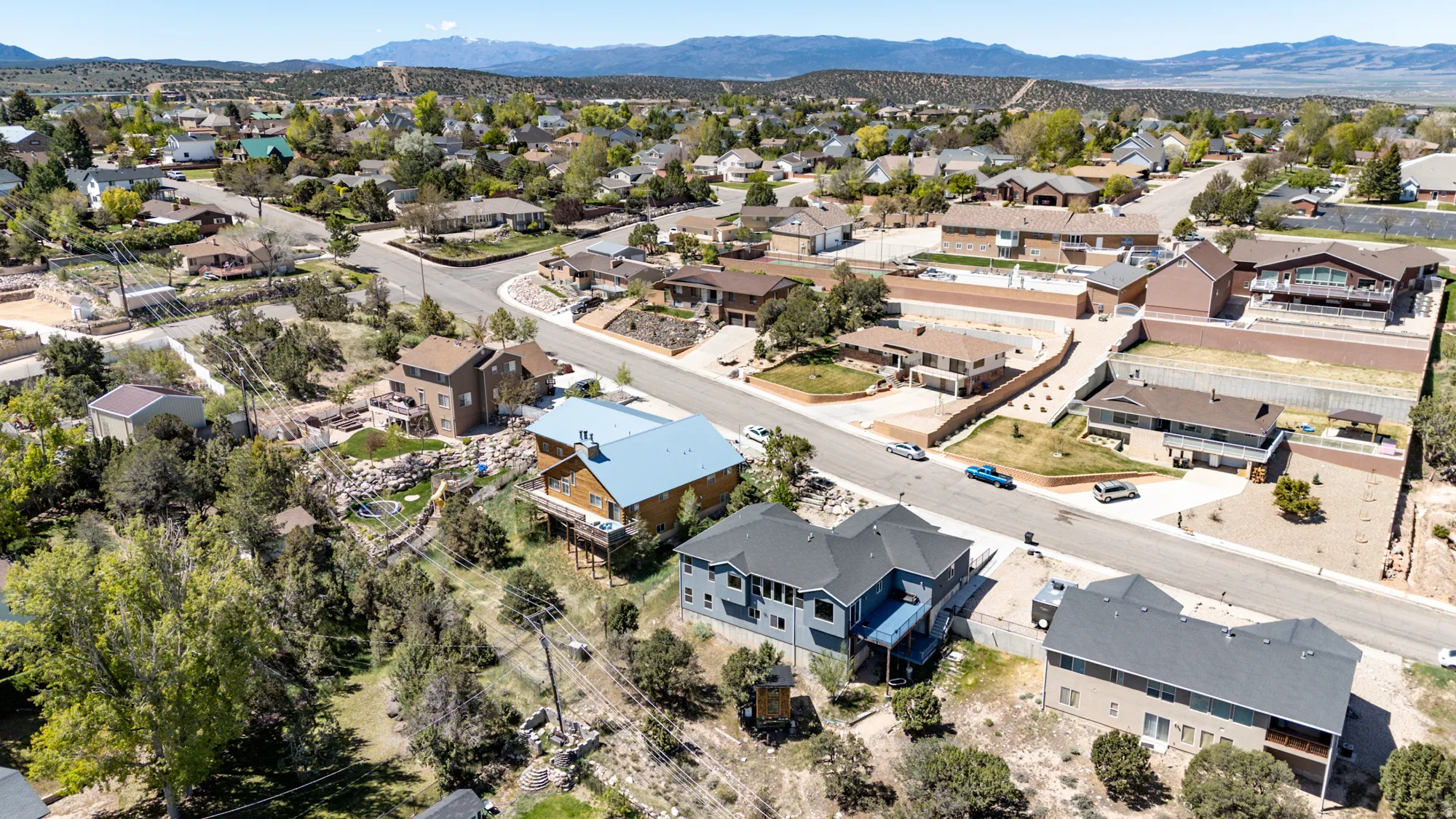 Elevated residential setting featuring varied architectural styles and mature landscaping