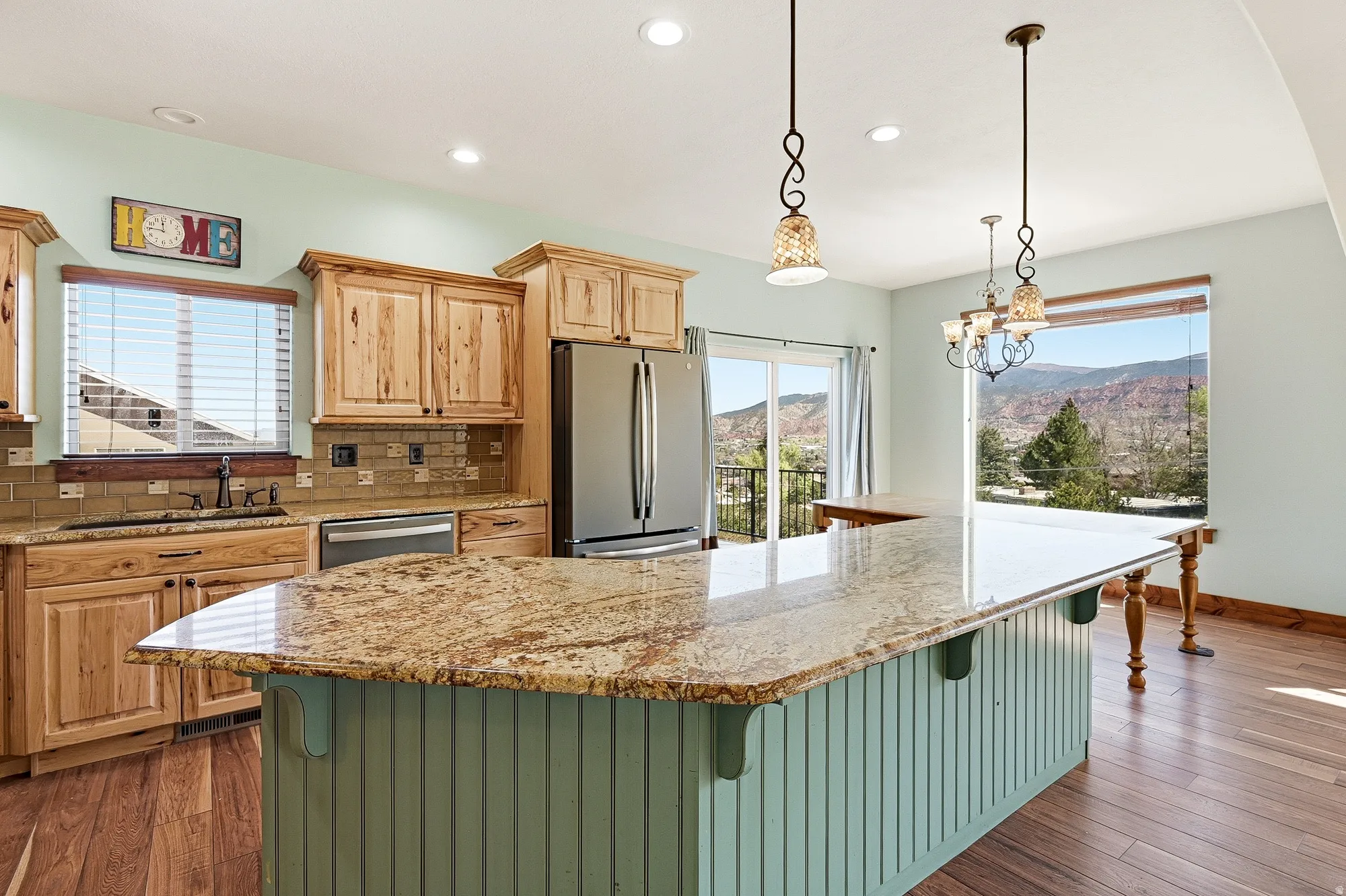 Kitchen featuring an expansive island with a granite countertop and beadboard base