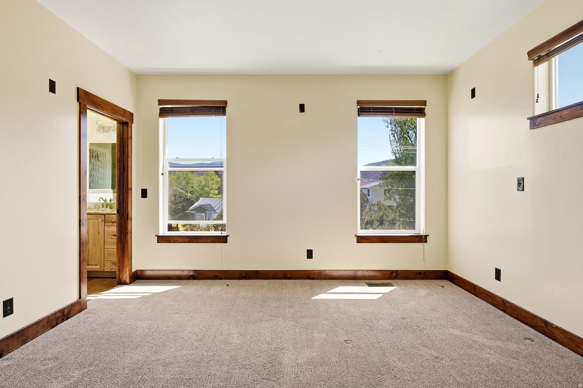 Cream-painted room with light brown carpeting