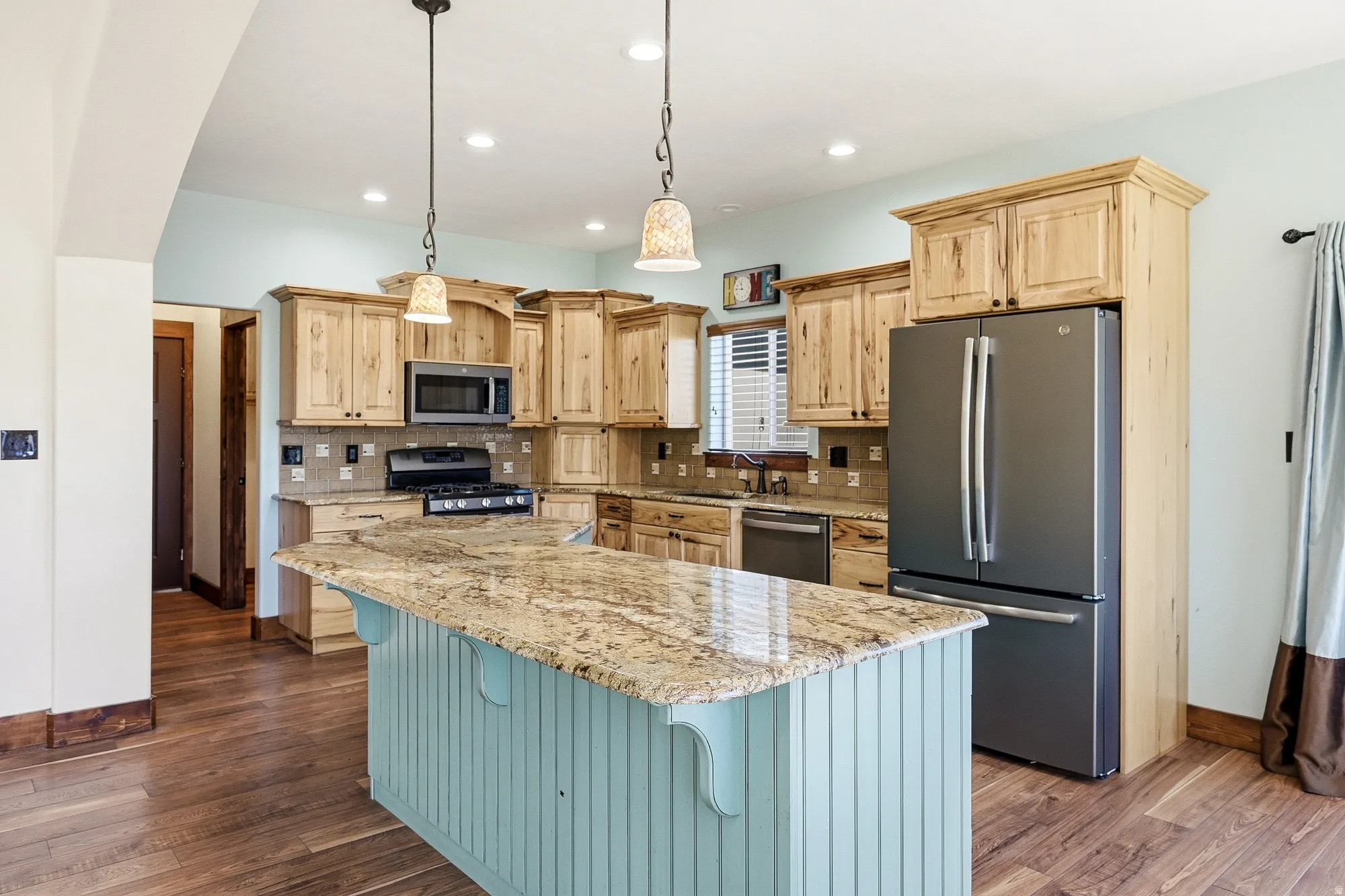 Kitchen featuring a central island with a granite countertop and beadboard paneling