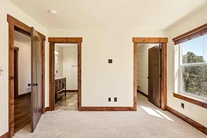 Neutral-toned wall finishes throughout a spacious room with plush carpeting