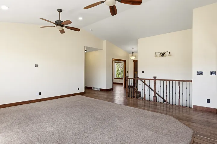 Spacious interior featuring vaulted ceilings and recessed lighting