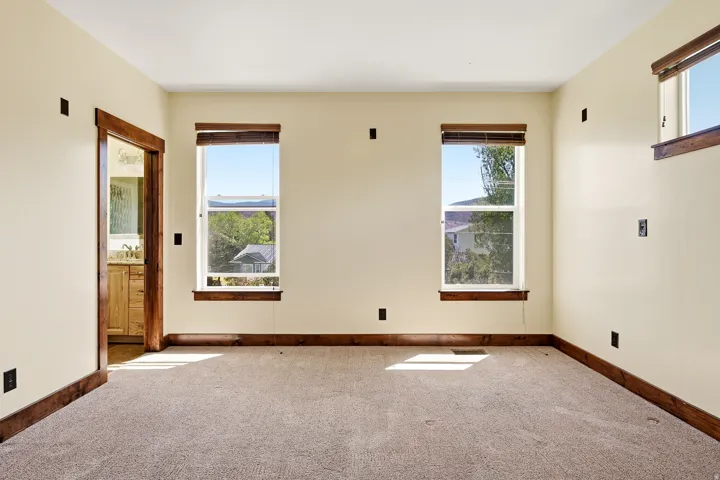 Cream-painted room with light brown carpeting