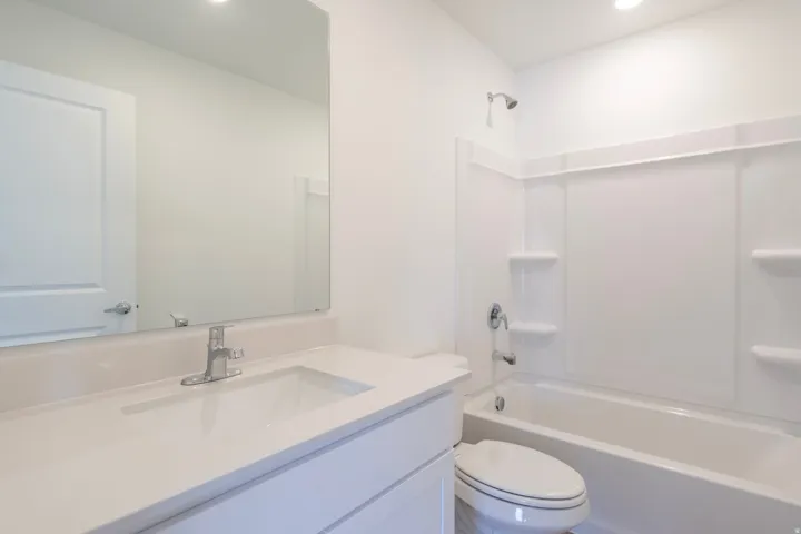 White vanity with integrated sink and chrome faucet