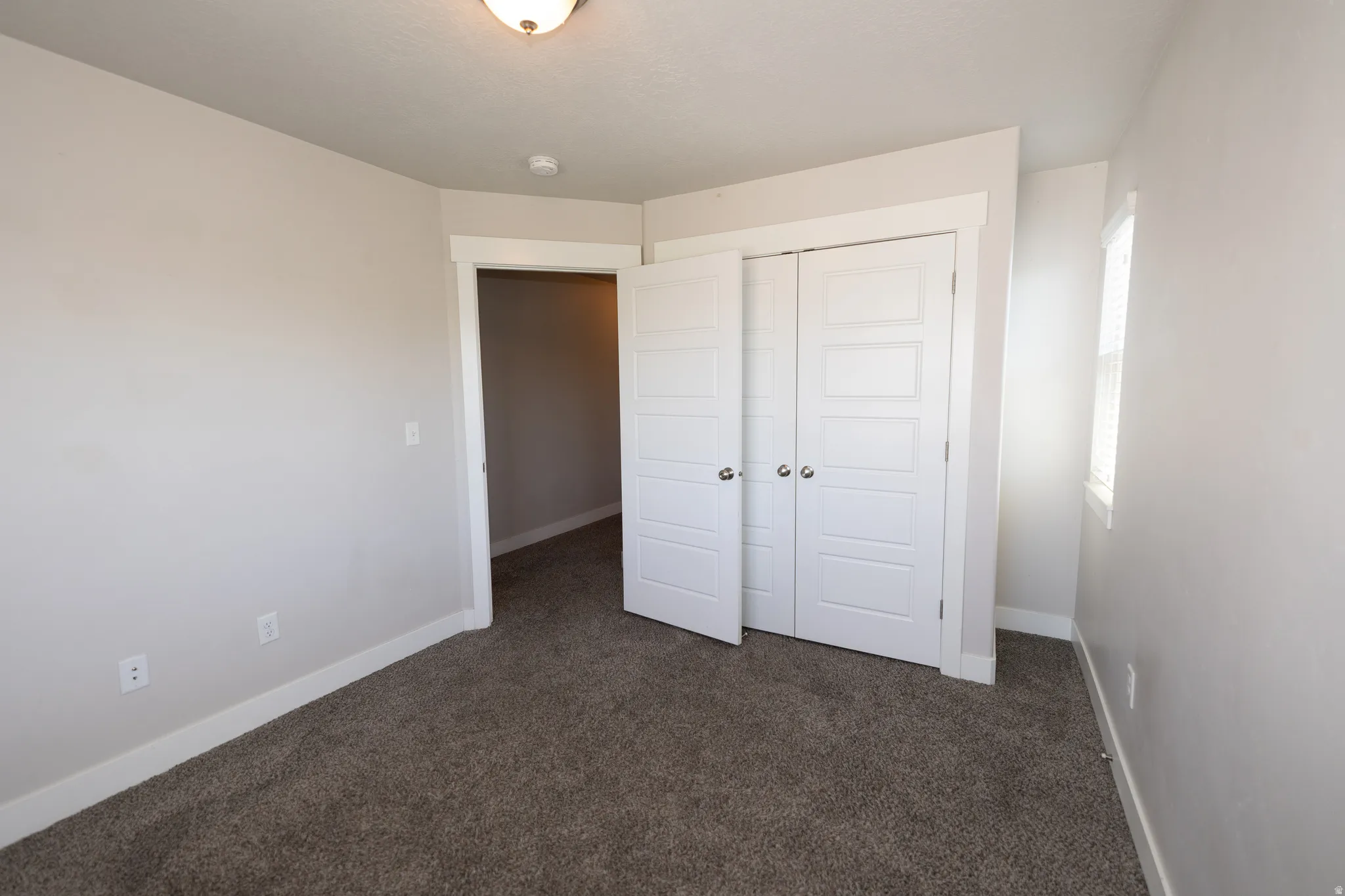 Neutral-toned interior with plush carpet flooring and white trim