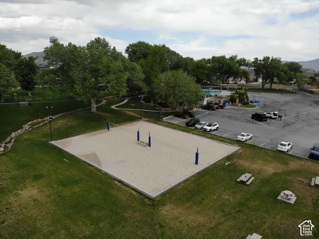 Sand volleyball court set within a grassy park area
