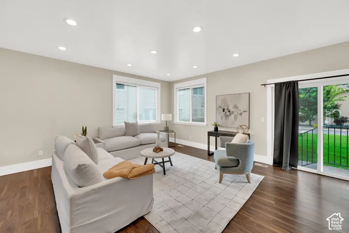 Spacious living area featuring wood-finish flooring, recessed lighting, and light-toned walls