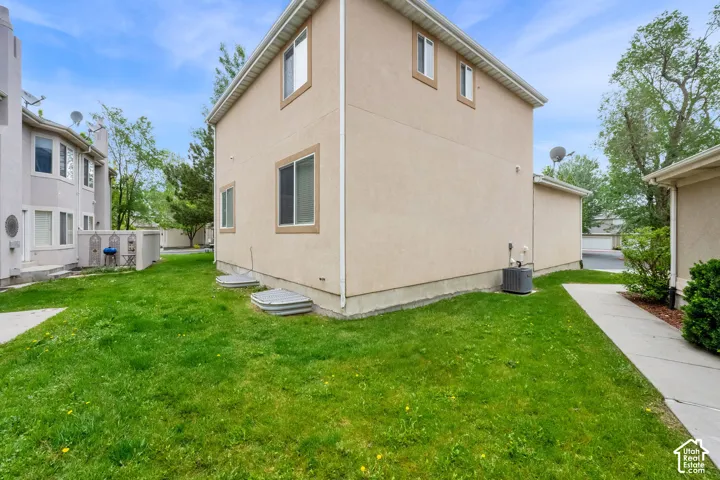 Exterior view featuring stucco siding, multiple windows, and a foundation