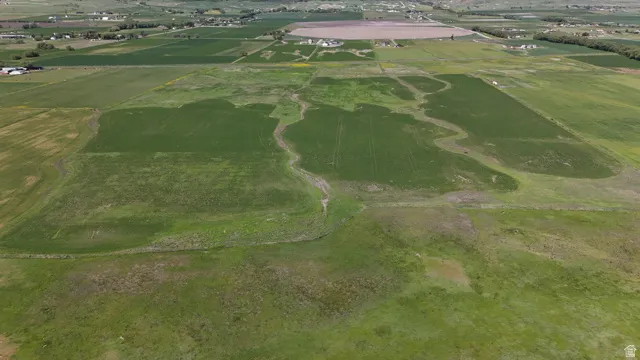 Expansive agricultural land featuring cultivated fields and open green spaces