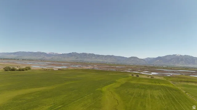 Expansive open fields with distant mountain range backdrop