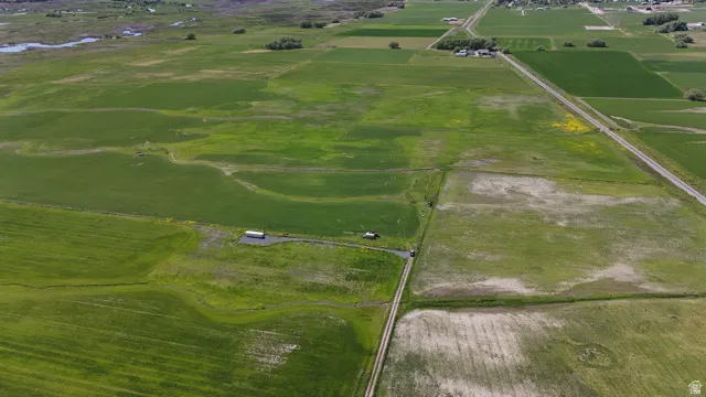 Expansive agricultural land featuring multiple cultivated fields and visible dirt paths