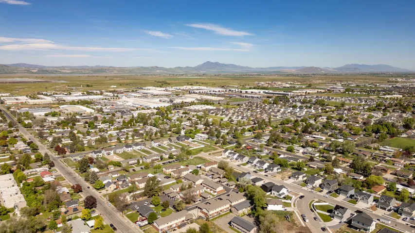Expansive aerial view of a residential area featuring numerous single-family homes and multi-unit residences