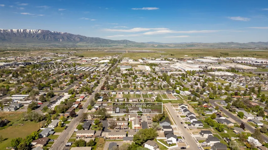 Aerial perspective showcasing a residential neighborhood with a mountainous backdrop