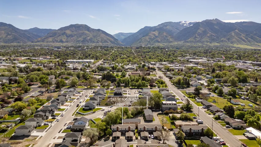 Aerial perspective showcasing a residential neighborhood with distant mountain ranges