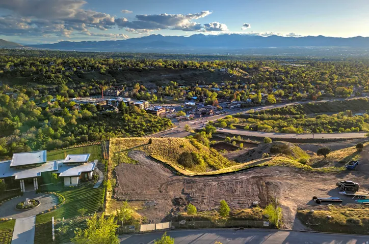 Expansive undeveloped lot featuring graded terrain and a prominent slope