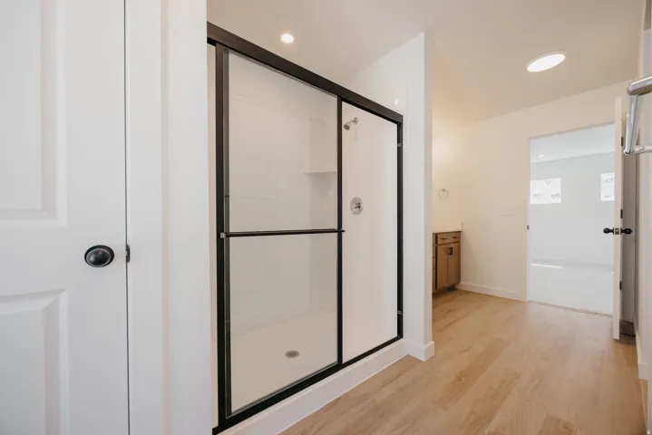 Walk-in shower with black-framed glass enclosure