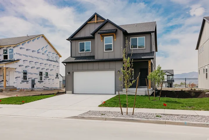 Contemporary two-story exterior featuring a dark gray siding facade and black trim