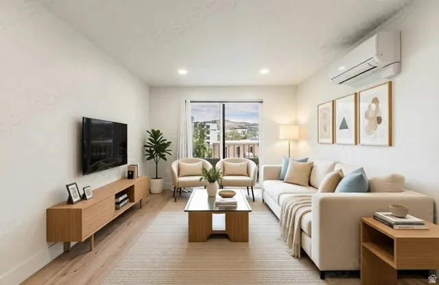 Living area with wood-finish flooring, recessed lighting, and white walls