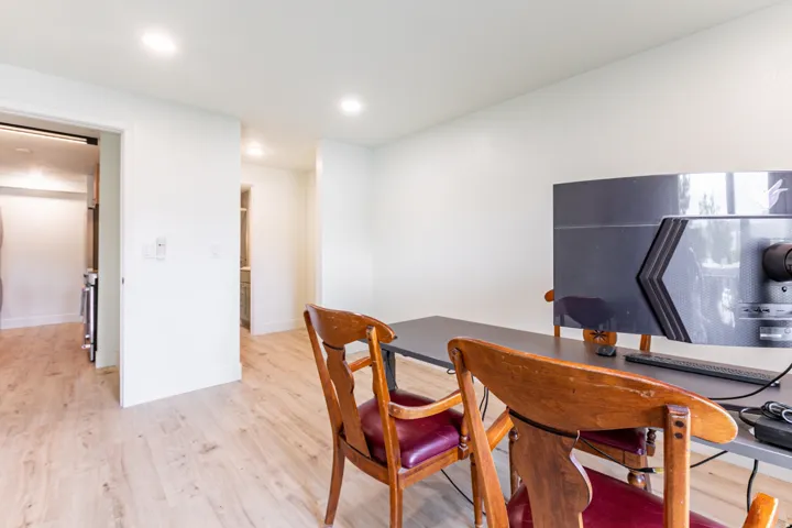 Bright interior space featuring light wood-finish flooring, white walls, and recessed ceiling lighting